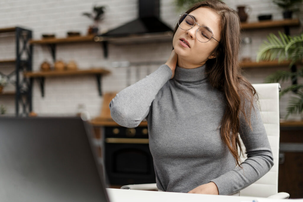 Working Woman Experiencing Neck Pain While Working
