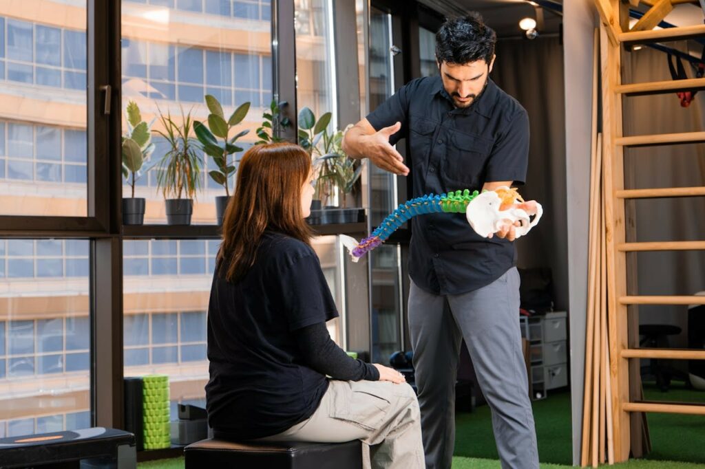 Chiropractor Demonstrating Chiropractic Work to Patient